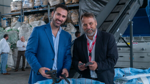 Donald Thomson (right), founder and CEO of CRDC, and David Zamora, commercial director of Pedregal, a construction company in Costa Rica, inspect plastics waste that will be made into RESIN8 concrete additive for buildings and other construction.