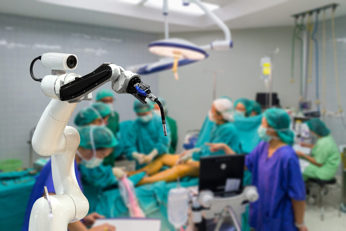 Surgical robot equipped with a camera waits to relay data about an invasive procedure.