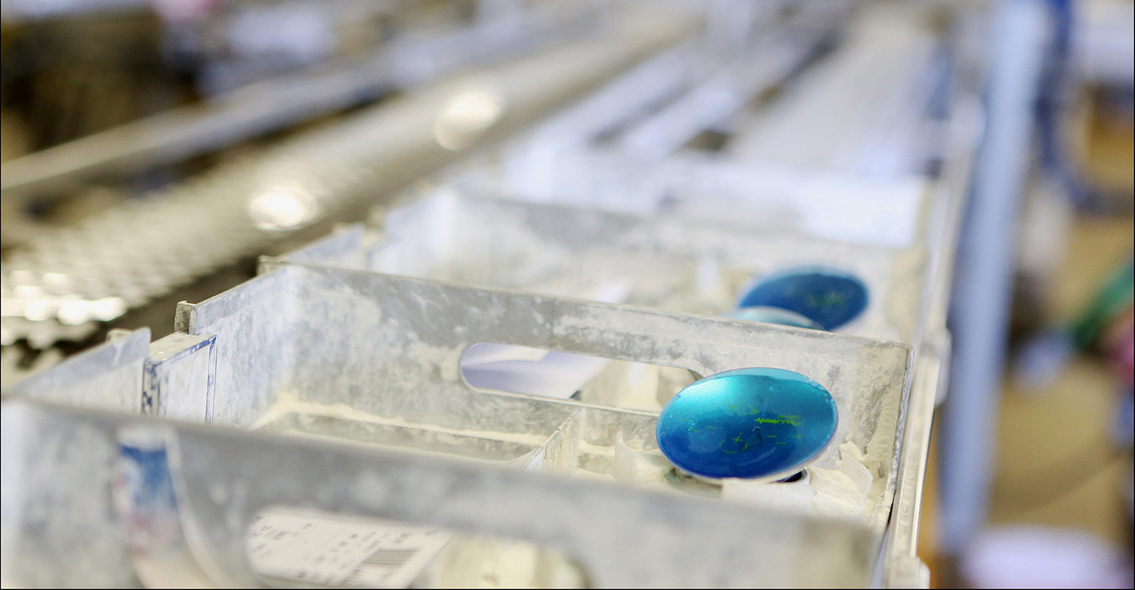 EssilorLuxottica is one of the largest makers of eyewear and lenses in the world. This image shows lens production in action. 