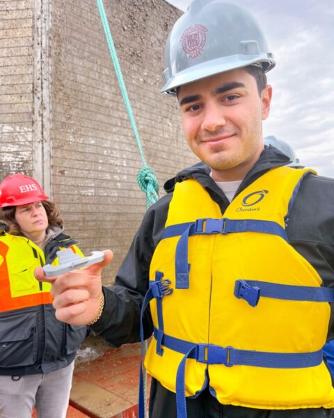 Mark Tarazi ’24, an engineering student who manages Cornell’s Rapid Prototyping Lab, holds the 3D-printed piece he made on the fly to help engineers perform a scrubbing to remove invasive mussels from Cornell’s Lake Source Cooling system.