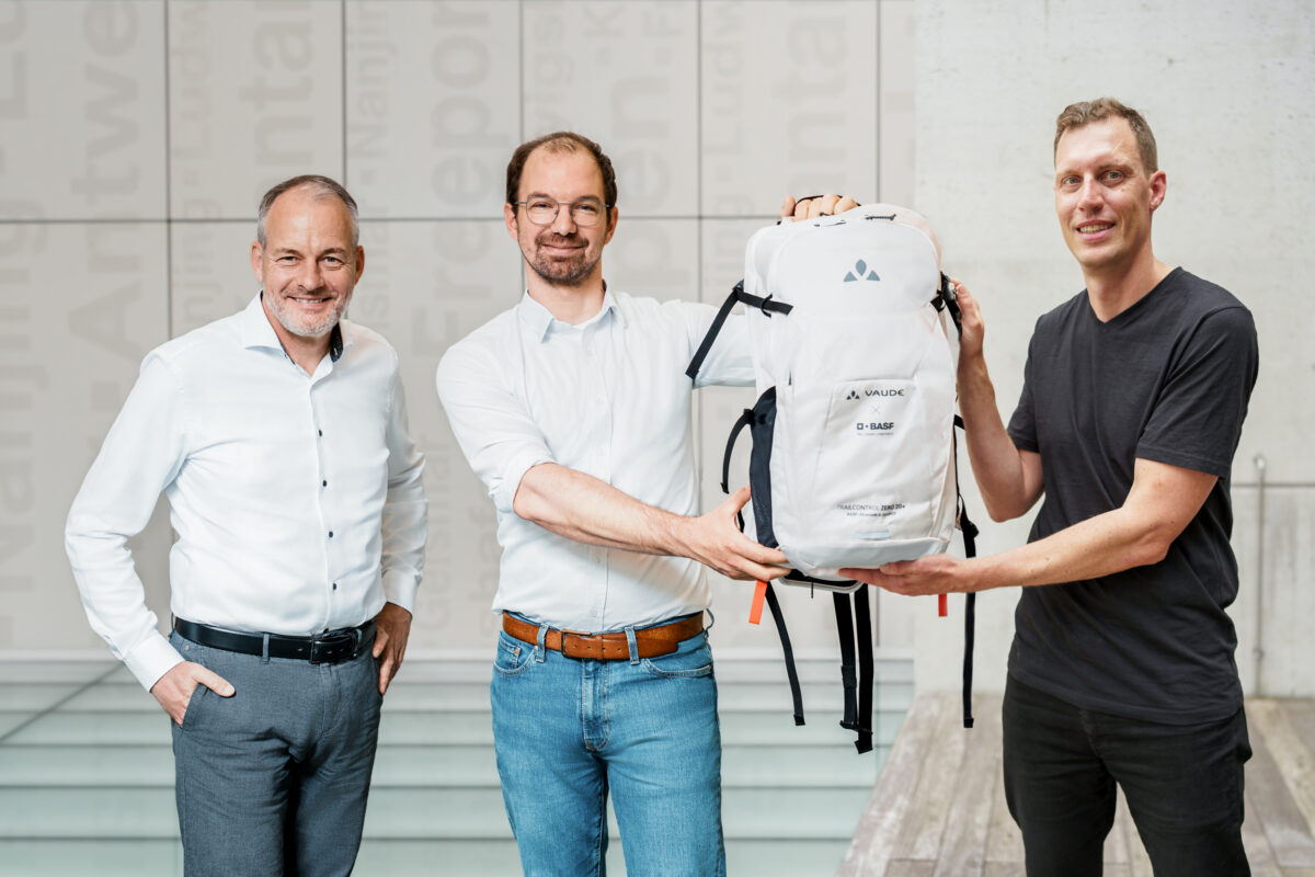 Frank Reil (BASF), Marcel Schmitt (BASF), and René Bethmann (VAUDE) with the new TRAILCONTROL ZERO 20+. Photo courtesy of BASF SE.