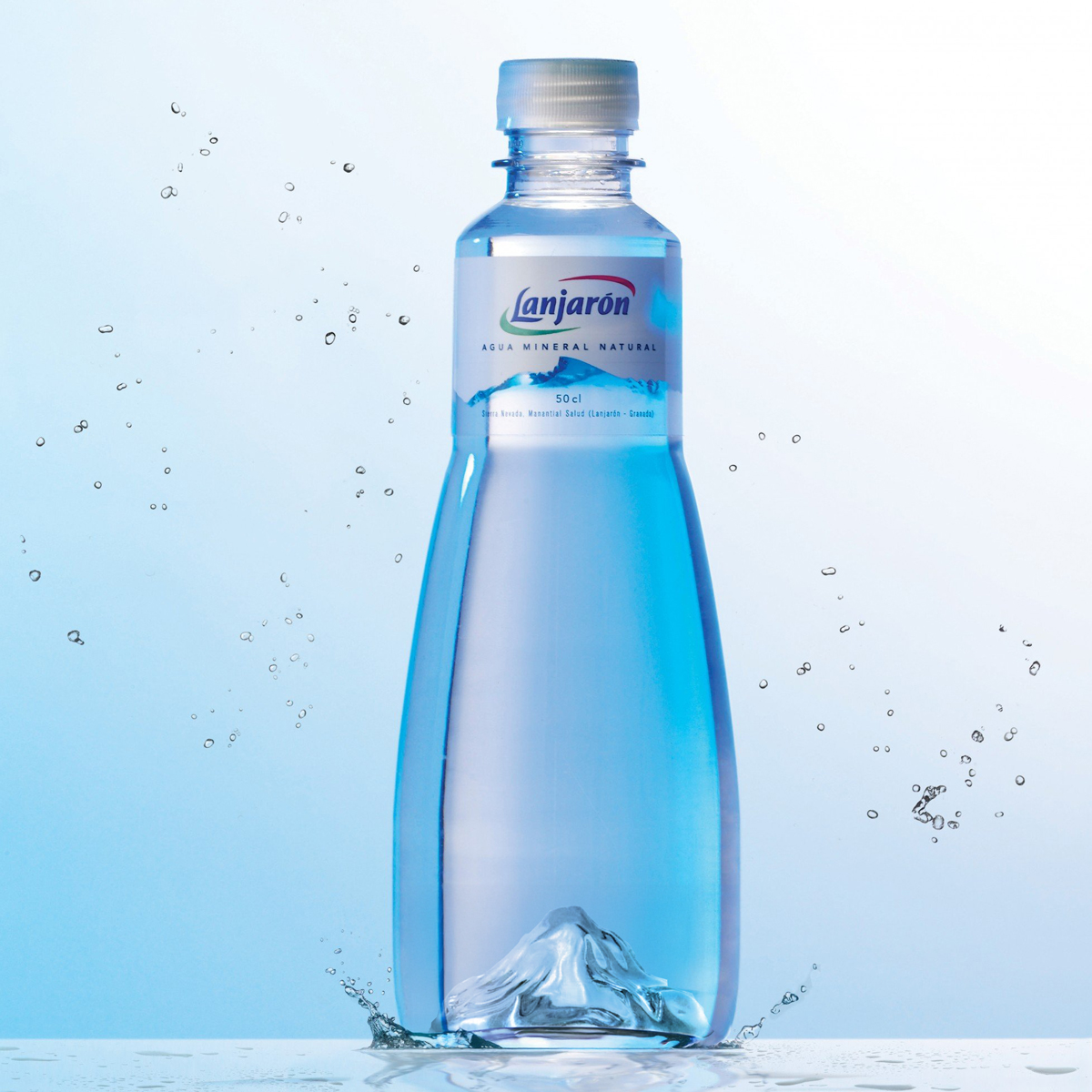 Lanjarón's premium water bottle features an innovative molded mountain relief at its base, directly inspired by Pico Mulhacén, the highest peak in the Iberian Peninsula and source of the water. The structural design challenges PET material limitations to create a premium experience that competes with glass bottles in the Horeca channel. Design by Tridimage.