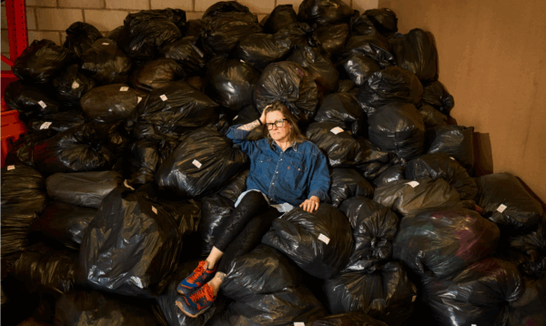 Wendy Ward with some of the 2,000kg of rag waste collected in just three days at St Luke’s hospice charity warehouse in Sheffield. Courtesy of Christopher Thomond/The Guardian.