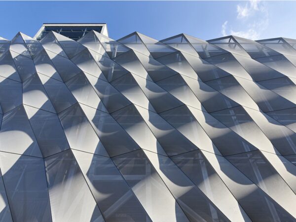Rigid PVC panel geometry on a building façade: interlocking profiles deliver dimensional stability, UV color hold, and controlled surface reflection at architectural scale. Courtesy of Canobbio.