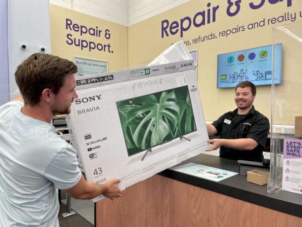A customer returns packaging from a television at a branch of Currys PC World. Courtesy of letsrecycle.com