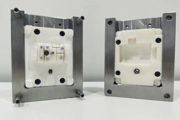 Hybrid tooling scheme in which the steel structure dictates the mechanical load path, thermal conductivity, and alignment constraints. High-temperature DLP/SLA inserts impose the cavity topology and enable accelerated iteration under full injection-cycle stress conditions. Courtesy of Formlabs.