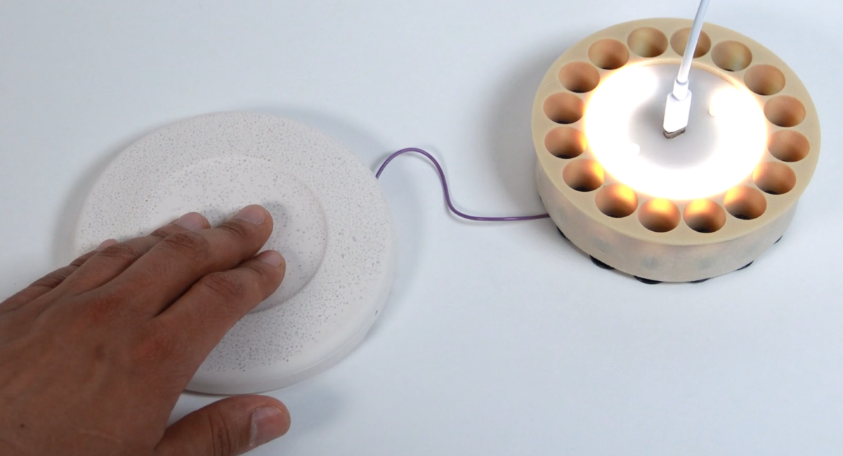 A proximity sensor in the top piece detects movement and responds by brightening a ring of LEDs as a hand moves closer. Courtesy of MIT Design Intelligence Lab.