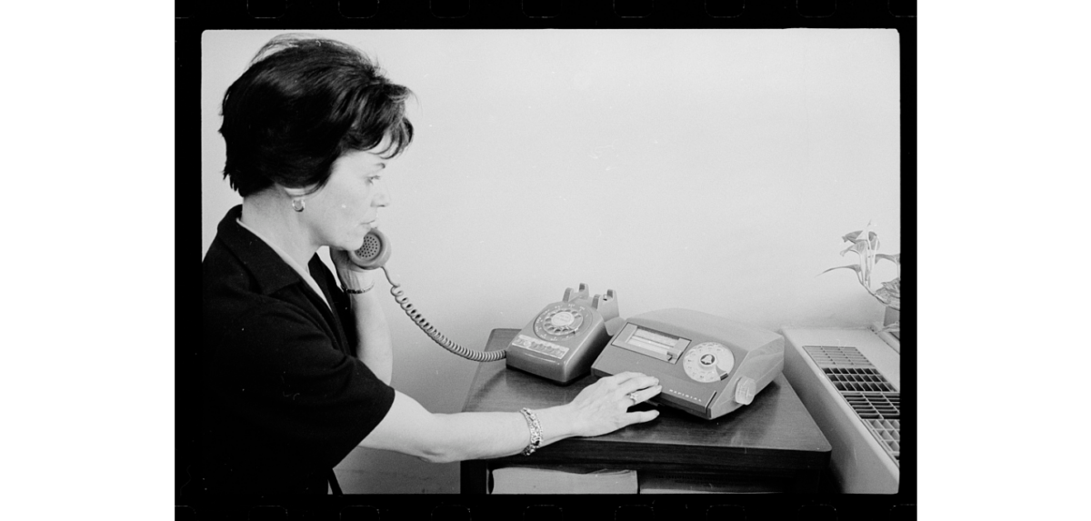 Women using a plastic-encased rotary phone and other electronic communication devices. Courtesy of Marion S. Trikosko at the Library of Congress.