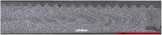 Longitudinal cross-section micrograph of a SF CF/LMPAEK coupon. The triangular ridges molded during panel production (visible at the top of the image) act as an energy director during welding. Courtesy of Robotic Sequential Ultrasonic Welding of Thermoplastic Composites: From Coupons to a Full-Scale Fuselage Demonstrator