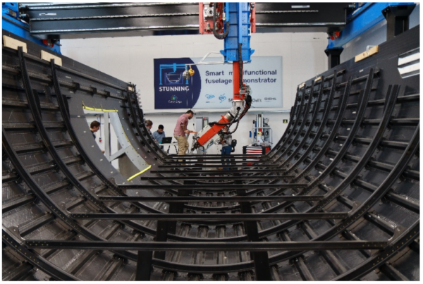The lower shell of the MFFD demonstrator after welding the frames to the clips. Courtesy of Robotic Sequential Ultrasonic Welding of Thermoplastic Composites: From Coupons to a Full-Scale Fuselage Demonstrator.